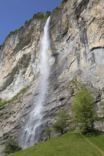 Waterfall flowing over mountain cliff, Staubbach Falls, Lauterbrunnen, Bernese Oberland, Switzerland, June