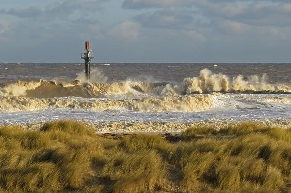 Waves breaking on sea defences during North Sea tidal surge, Norfolk, England, December 2013