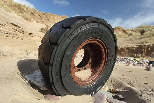 Wheel washed up in sand dune, Gower Peninsula, West Glamorgan, South Wales, March
