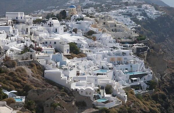 White-washed buildings and swimming pools, in town on coastal clifftop, Oia, Santorini, Cyclades, Aegean Sea, Greece