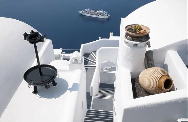 White-washed villa hotel building and cruise ship at sea, Fira, Santorini, Cyclades, Aegean Sea, Greece, September