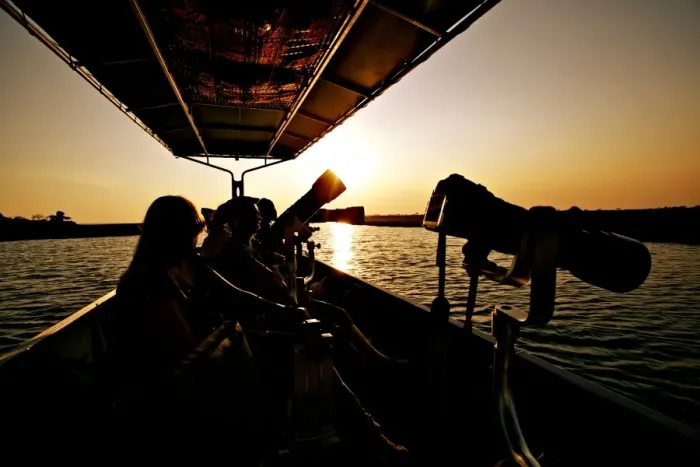 Framed Print : Wildlife photographers on boat, silhouetted at sunset, Chobe River, Chobe N. P. Botswana, July Framed Print : Wildlife photographers on boat, silhouetted at sunset, Chobe River, Chobe N. P. Botswana, July