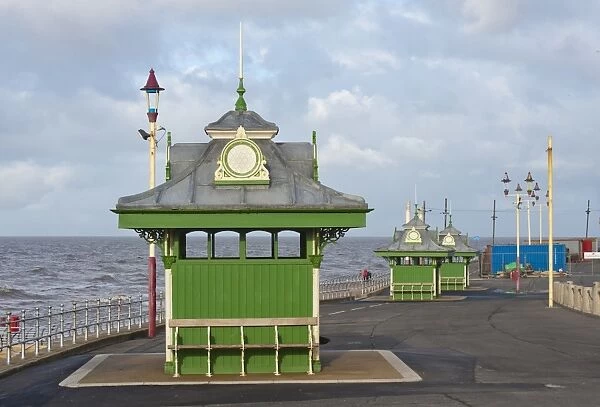 Wind shelters beside sea in seaside resort town, Blackpool, Lancashire, England, january