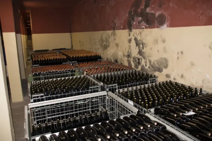 Framed Print : The wine cellar of Guasti Clemente with bottles of wine waiting to be labelled