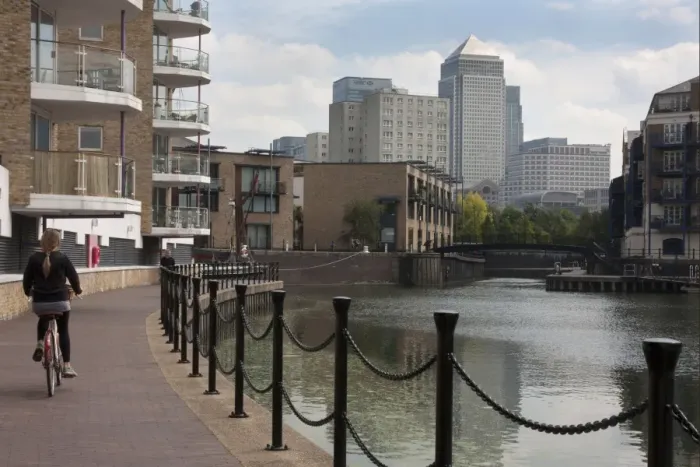 Framed Print : Woman cycling beside waterway with redevelopment, Canary Wharf in distance, Limehouse Basin, Limehouse, Tower Hamlets Framed Print : Woman cycling beside waterway with redevelopment, Canary Wharf in distance, Limehouse Basin, Limehouse, Tower Hamlets