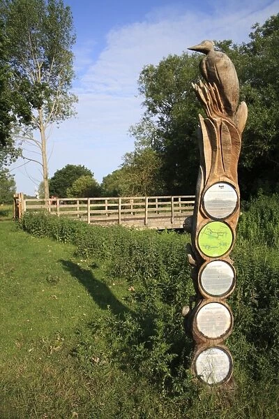 Wooden sculpture and information signpost, near bridge over river in fen habitat, Little Ouse Headwaters Project