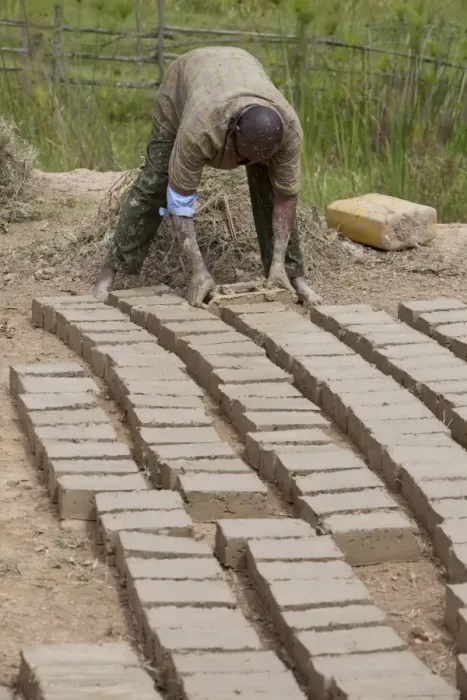 Framed Print : Worker forming loam bricks, Uganda Framed Print : Worker forming loam bricks, Uganda