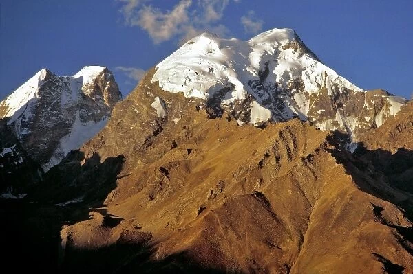 Asia, India, Ladakh, Padum. Late light illuminates the snowy tops of the Himalayas