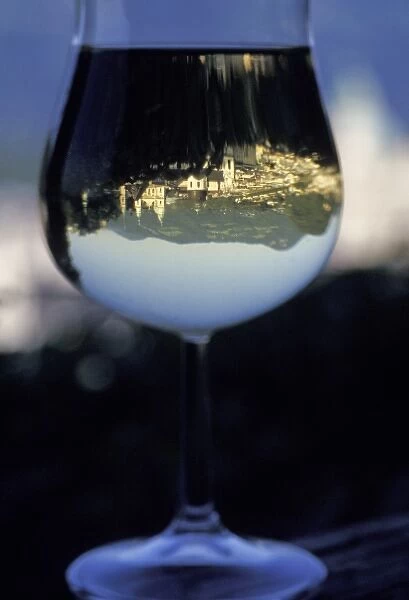 Austria, Salzburg. Old town architecture reflected in a wine glass
