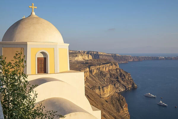 Domed church with steeple in town of Fira, Santorini, Greece