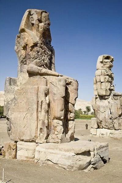 Egypt, Thebes. The six-story-high faceless Colossi of Memnon were badly damaged by