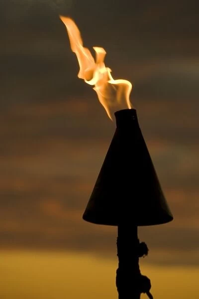 Fiji, Viti Levu, Lautoka. Tiki torch against evening sky