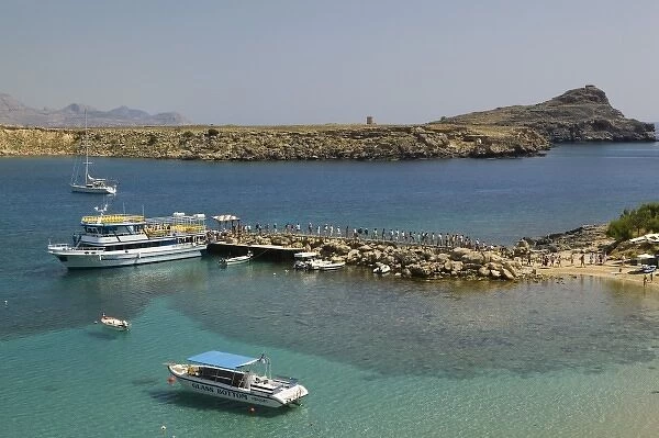GREECE, Dodecanese Islands, RHODES, Lindos: Lindos Harbor, Tour boat with visitors