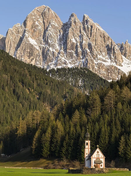 The peaks of the Geisler mountain range in valley Villnoess. The church Sankt Johann in Ranui (St