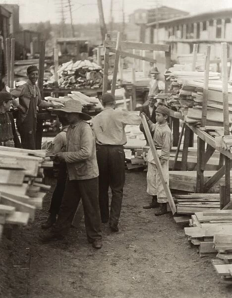 HINE: CHILD LABOR, 1910. Young boys working for Hickok Lumber Co. in Burlington, Vermont