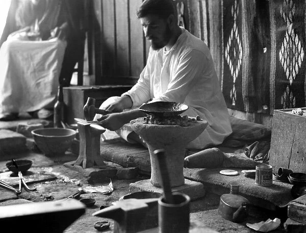 IRAQ: BLACKSMITH, 1932. A Iraqi man working as a blacksmith, Iraq. Photograph, 1932