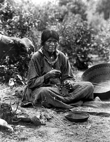 PAIUTE BASKET MAKER, c1902. A Paiute woman making a basket. Photograph by Charles C