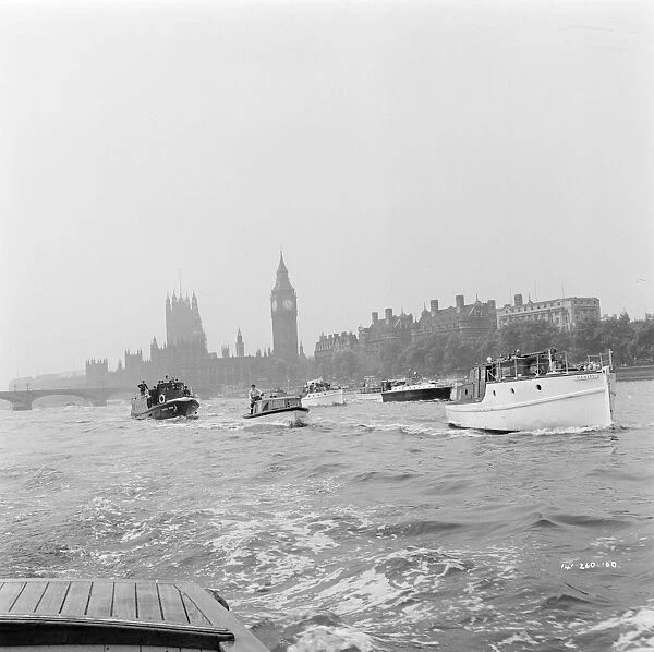 Small boats on the Thames with The Houses of Parliament in the background
