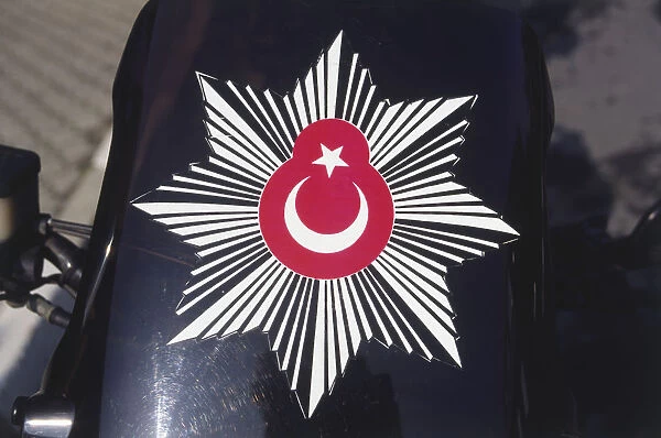 Asia, Turkey, badge of the Turkish police, red Turkish flag inside black and white eight-pointed star, displayed against black background