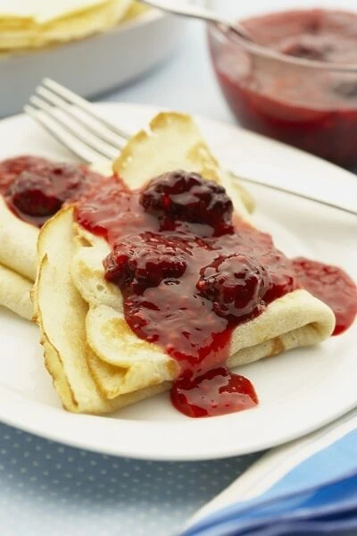 Boiled raspberries on pancakes