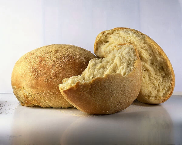 Whole and broken loaves of Pane, Semolina bread