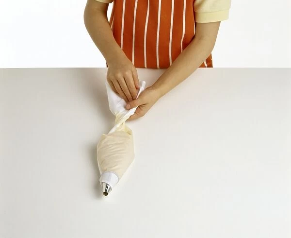 Cook twisting top of piping bag, pastry filling bag