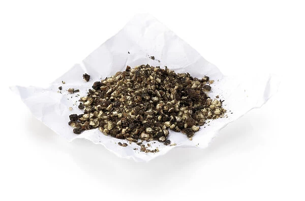 Crushed black pepper on white paper