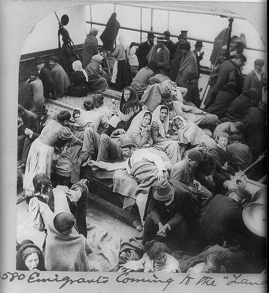 Immigrants, probably Russian or Polish, on board a boat approaching New York, USA