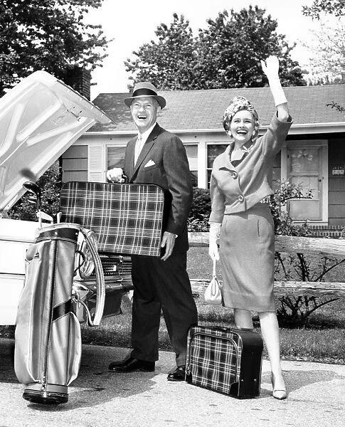 Mature couple loading car trunk for a trip