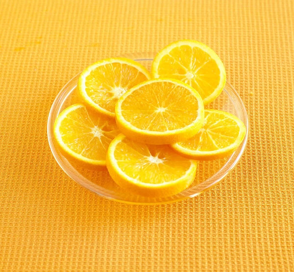 Orange slices on glass plate, close up