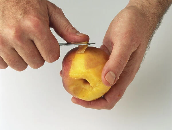 Peach being peeled with knife
