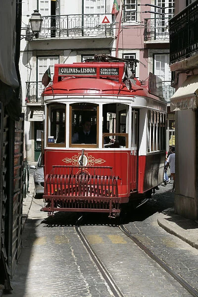Portugal, Lisbon, red tourist tram on narrow road