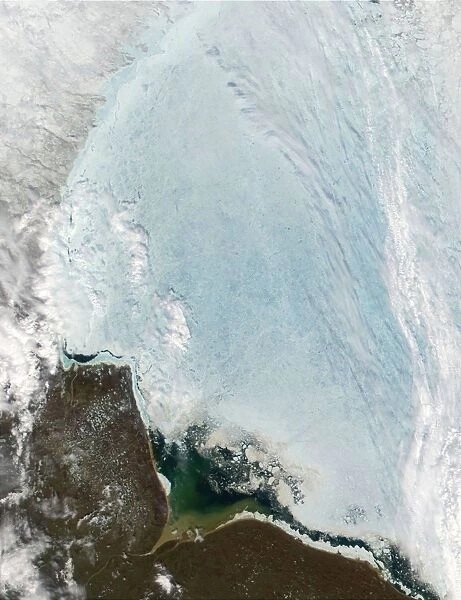 satellite view over Hudson Bay, Canada. Large ice flow is shown over the bay