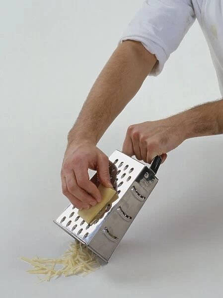 Using metal grater to grate gruyere cheese
