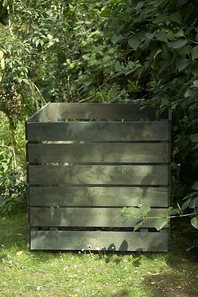 Wooden compost bin in garden