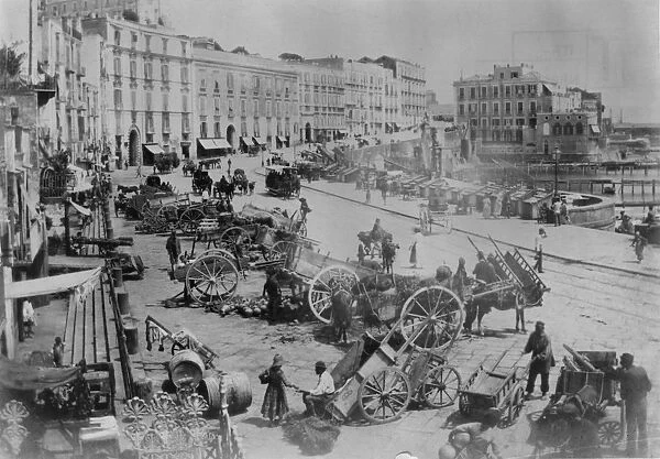 Naples. circa 1870: A street in Naples by the harbour with stalls being set up
