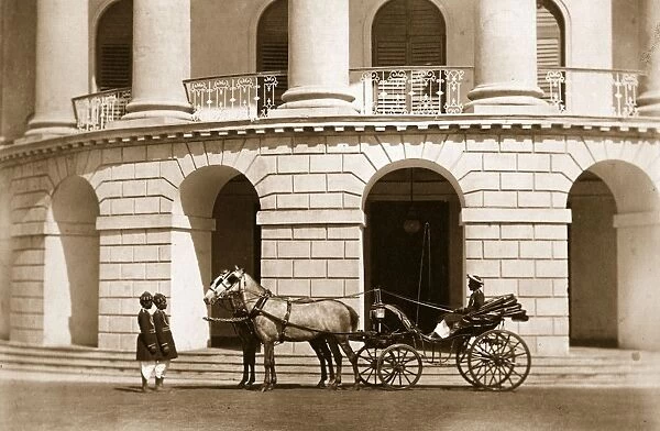 The Raj. circa 1890: A private carriage outside an impressive portico with