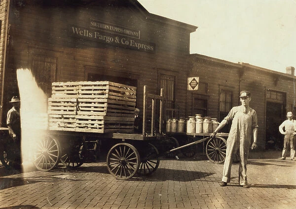 Men in front of a Wells Fargo & Co Express depot with crates and milk cans, Springfiled