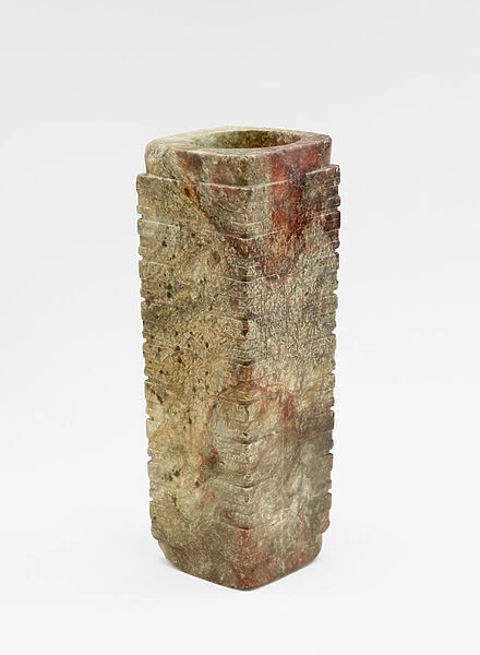 Nine-tier tube (cong ceA) with masks, c. 3300-2250 BC (jade, nephrite)