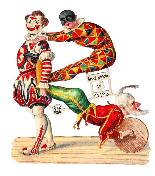 A Victorian Paper Scrap Relief of a clown, a jester and a harlequin performing gymnastics