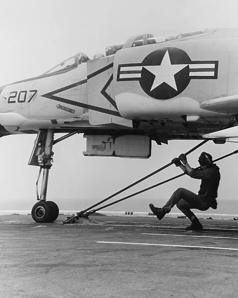 An F-4B Phantom II fighter plane is readied for launch from USS Coral Sea, 1969