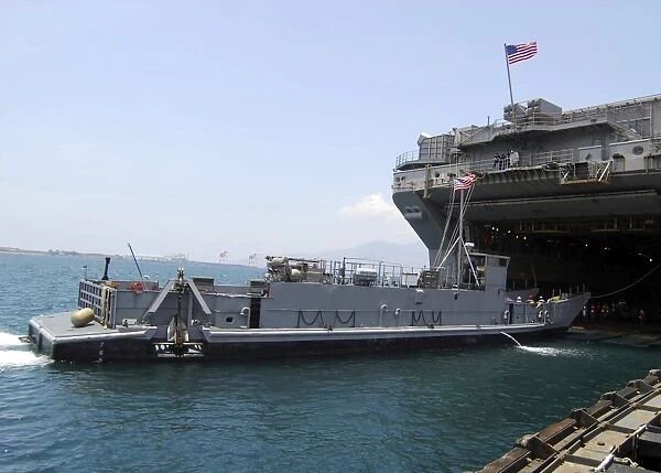Landing Craft Utility moving into position near amphibious assault ship USS Essex in Subic Bay