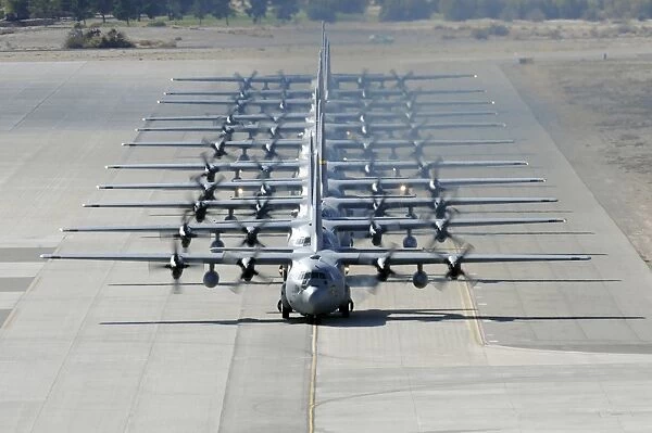 A line of C-130 Hercules taxi at Nellis Air Force Base, Nevada