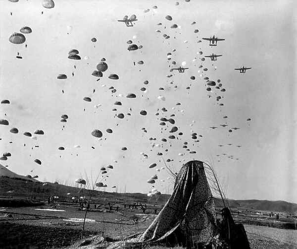 Paratroopers jump from from C-119s over Korea