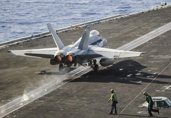 A U. S. Navy F  /  A-18C Hornet launches from the flight deck of USS Nimitz