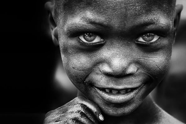 Kid's smile, miner's hands - Benin