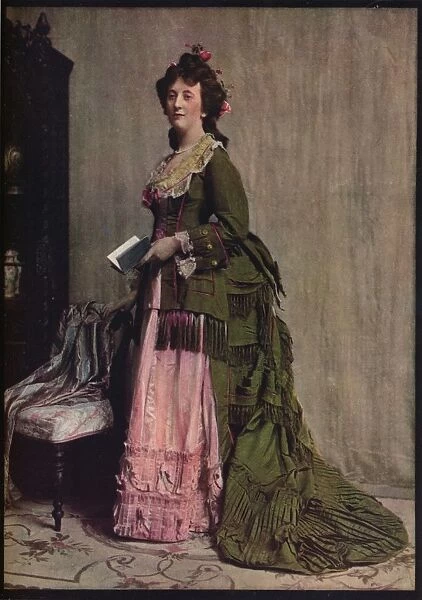 An afternoon dress of green and pink silk. Very typical of the modes between 1868 and 1878, c1913