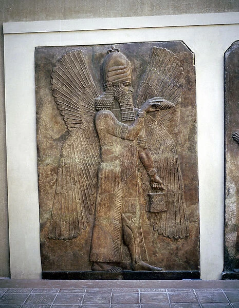 Assyrian relief of a winged genie with a bucket & a cedar cone, Khorsabad, 8th century BC