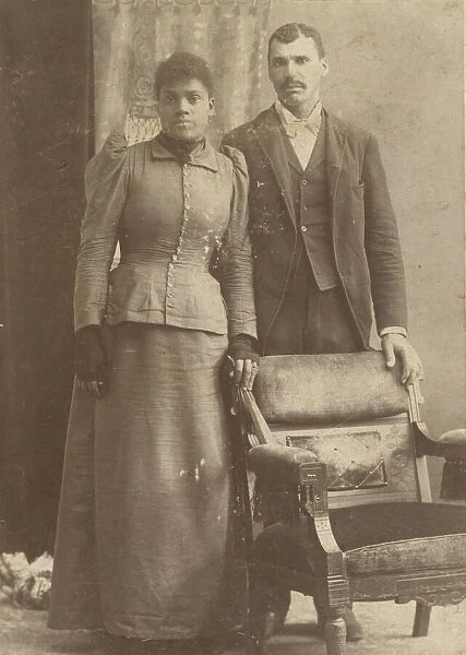 Photograph of an African-American couple standing behind a chair, ca. 1890
