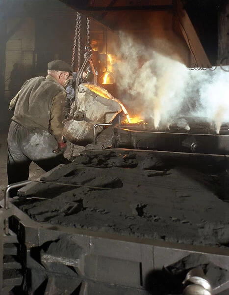 Pouring molten metal from a cupola into moulds, steel bath production, Hull, Humberside, 1965
